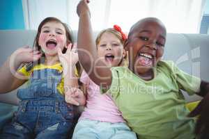 Happy kids laughing while sitting down