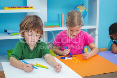 School kids making art at their desk