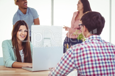 Young creative worker smiling at camera