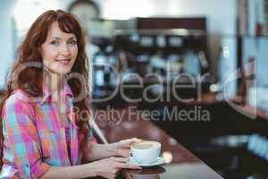 Mature student smiling in cafe