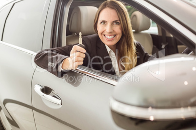 Smiling businesswoman holding car key