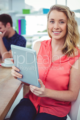 Smiling creative businesswoman working with co-workers