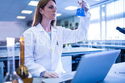 Scientist working with a laptop in laboratory