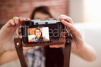 Asian woman on the couch taking selfie