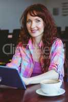 Mature student using tablet in cafe