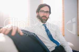 Happy businessman sitting on couch