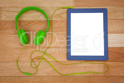 View of a green headphone with a blue tablet