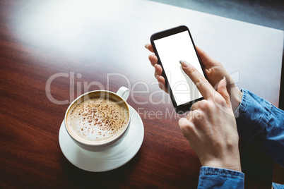 Woman taking a photo of her coffee