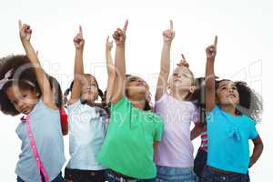 Line of girls standing with hands pointing up