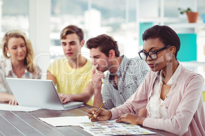 Creative business team working hard together on laptop