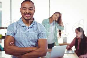 Young creative worker smiling at camera