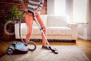 Woman hoovering the rug