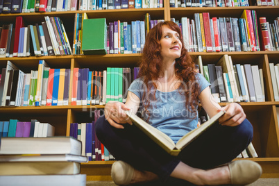 Mature student reading book in library Mature student reading book in library