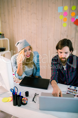 Creative team working at desk with laptop