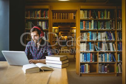 Hipster student studying in library