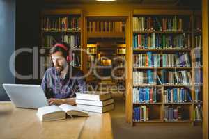 Hipster student studying in library