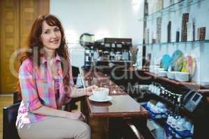 Mature student smiling in cafe
