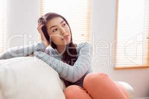 Asian woman relaxing on couch