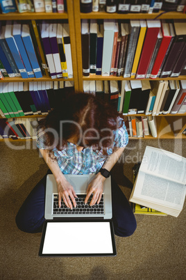 Mature student in library using laptop