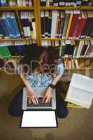 Mature student in library using laptop