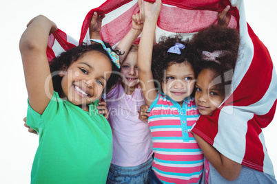 Girls standing with american flag overhead