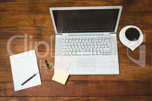 View of a grey laptop with coffee