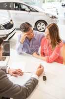 Smiling couple buying a new car