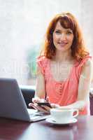 Mature student using laptop in cafe