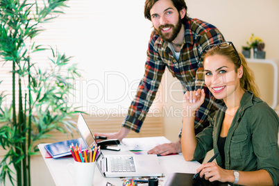 Creative team working at desk with laptop