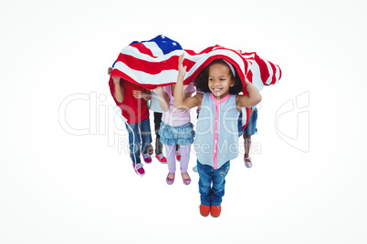 Girls standing with american flag overhead