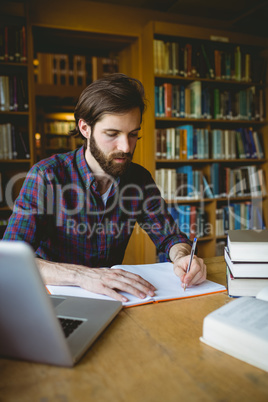 Hipster student studying in library