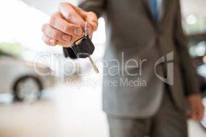 Close up of businessman giving car key