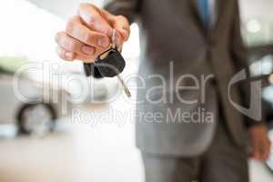 Close up of businessman giving car key