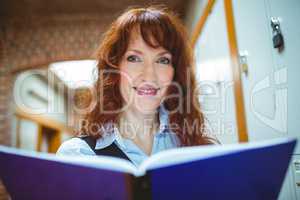 Mature student smiling at camera in hallway