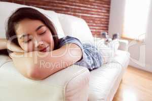 Asian woman napping on couch