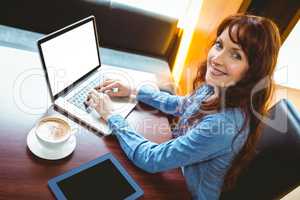 Mature student using laptop in cafe
