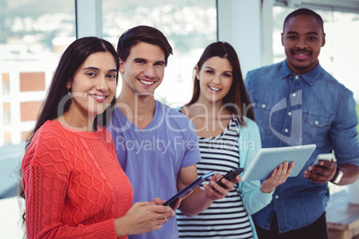 Young creative team looking at phones and tablets