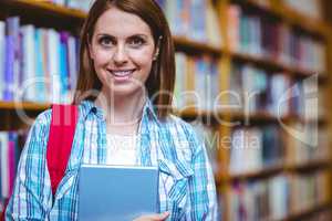 Mature student in the library using tablet