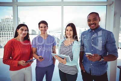 Young creative team looking at phones and tablets