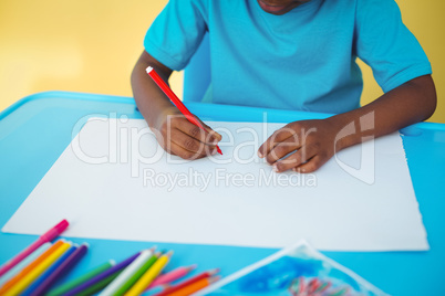 School kid drawing on a sheet