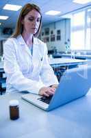 Scientist working with a laptop in laboratory