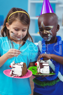 Happy kids eating birthday cake