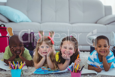 Smiling kids drawing pictures on paper