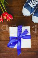 View of sneakers and blue gift