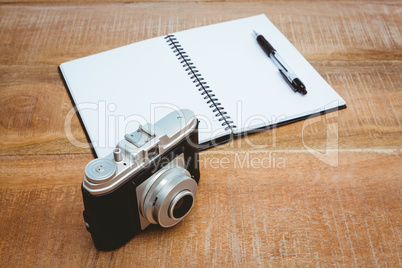 View of an old camera and a notebook