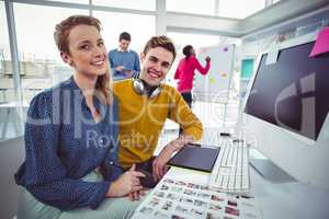 Graphic designer wearing headphones at desk