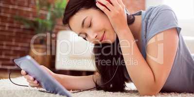 Asian woman using tablet on floor