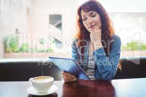Mature student using tablet in cafe