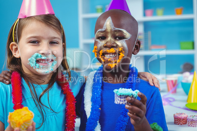 Smiling kids with icing on their faces