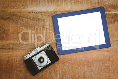 View of an old camera and a blue tablet